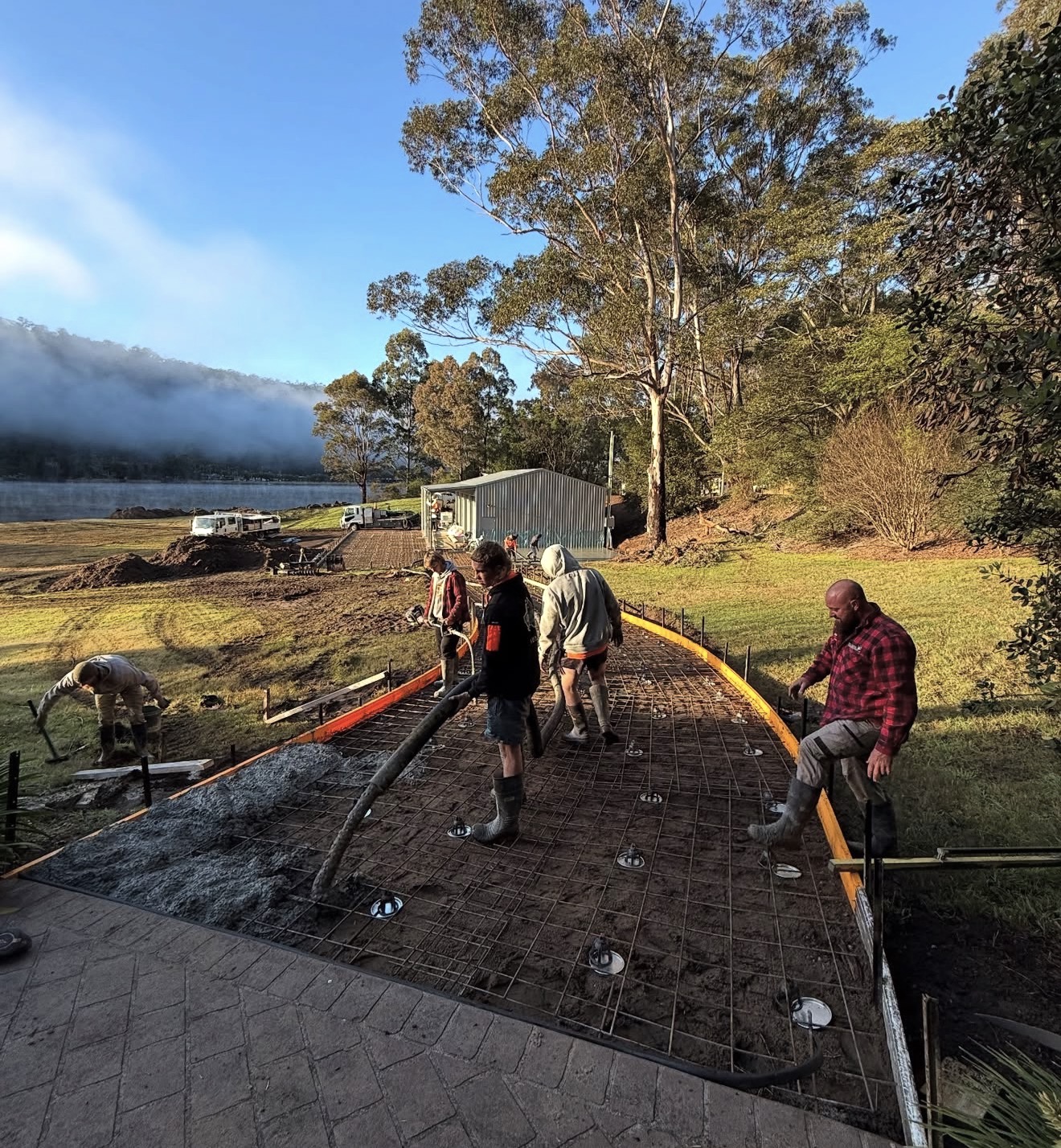 Starkys Concrete Pumping crew pouring a slab on site